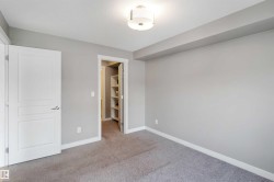 Unfurnished bedroom featuring a walk in closet and carpet flooring - 