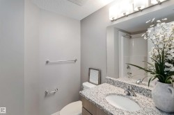 Full bathroom featuring vanity, washtub / shower combination, and a textured ceiling - 
