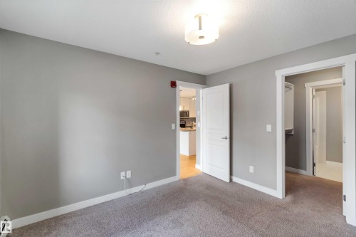 Unfurnished bedroom featuring carpet floors and baseboard heating - 101 3670 139 Avenue, Edmonton, AB - Indoor Photo Showing Other Room