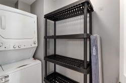 Laundry room with stacked washer and clothes dryer - 