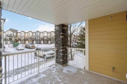 Snow covered back of property with a residential view - 