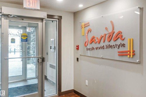 Doorway to outside featuring radiator heating unit, wood finished floors, and recessed lighting - 101 3670 139 Avenue, Edmonton, AB - Indoor Photo Showing Other Room