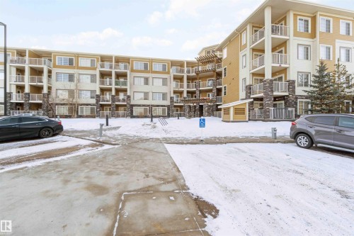 Snow covered property with a view of apartment building / complex - 101 3670 139 Avenue, Edmonton, AB - Outdoor With Balcony With Facade