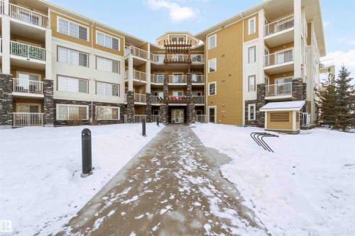 Snow covered property with a view of apartment building / complex - 101 3670 139 Avenue, Edmonton, AB - Outdoor With Balcony With Facade