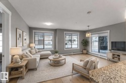 Living room with light wood-type flooring and baseboard heating - 