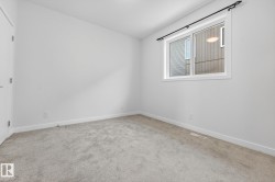 Spare room featuring light colored carpet and baseboards - 
