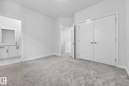 Unfurnished bedroom with light carpet, a closet, and ensuite bath - #5 15805 97 Ave, Edmonton, AB - Indoor Photo Showing Other Room