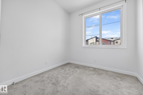 Carpeted spare room featuring baseboards and vaulted ceiling - #5 15805 97 Ave, Edmonton, AB - Indoor Photo Showing Other Room