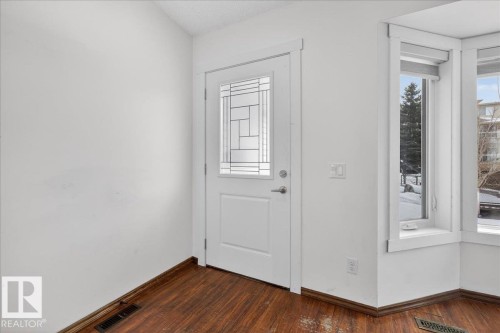 Entryway with dark wood-style floors and baseboards - 2516 42 Street, Edmonton, AB - Indoor Photo Showing Other Room
