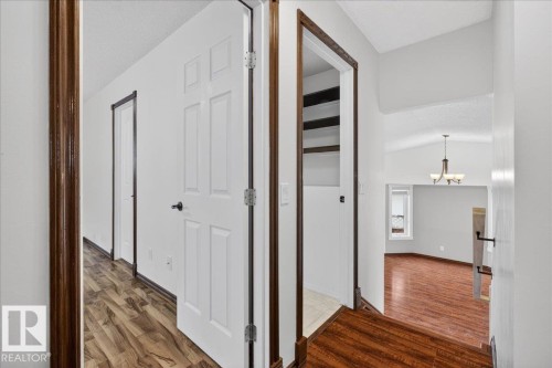 Corridor with dark wood-type flooring, a chandelier, lofted ceiling, and a textured ceiling - 2516 42 Street, Edmonton, AB - Indoor Photo Showing Other Room