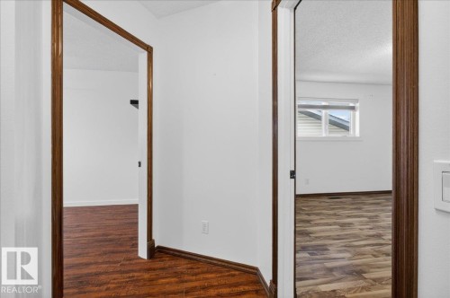 Hall featuring dark wood finished floors and a textured ceiling - 2516 42 Street, Edmonton, AB - Indoor Photo Showing Other Room