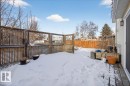 Yard layered in snow featuring a fenced backyard and a deck - 2516 42 Street, Edmonton, AB  - Outdoor With Deck Patio Veranda 