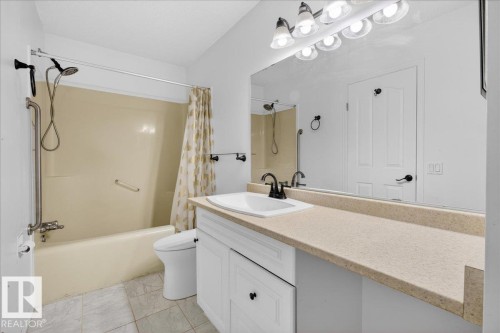Full bathroom with vanity and shower / bath combo with shower curtain - 2516 42 Street, Edmonton, AB - Indoor Photo Showing Bathroom