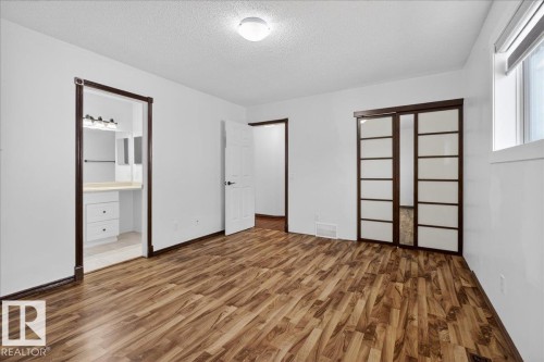 Unfurnished bedroom with wood finished floors, a closet, and a textured ceiling - 2516 42 Street, Edmonton, AB - Indoor Photo Showing Other Room