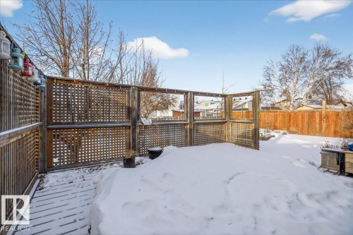 Yard covered in snow featuring a fenced backyard and a wooden deck - 2516 42 Street, Edmonton, AB - Outdoor With Deck Patio Veranda