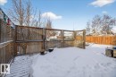 Yard covered in snow featuring a fenced backyard and a wooden deck - 2516 42 Street, Edmonton, AB  - Outdoor With Deck Patio Veranda 