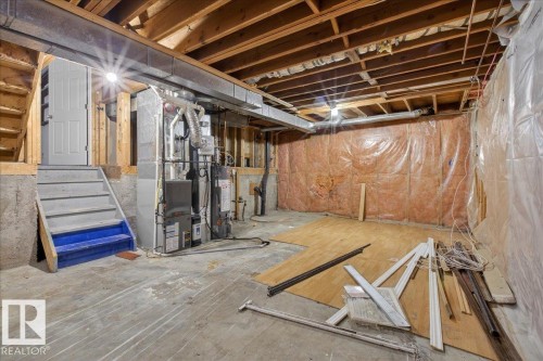 Unfinished basement with heating unit and water heater - 2516 42 Street, Edmonton, AB - Indoor Photo Showing Basement