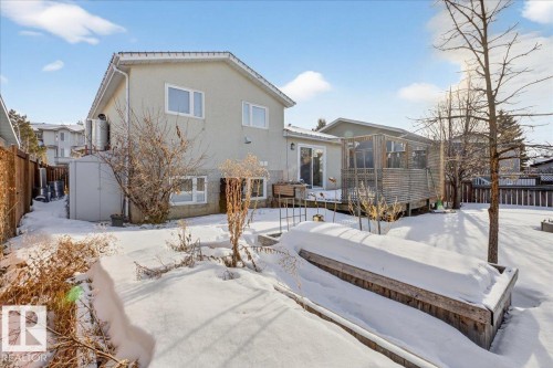 Snow covered rear of property with a fenced backyard, a storage shed, and stucco siding - 2516 42 Street, Edmonton, AB - Outdoor