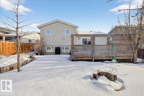 Snow covered back of property with a deck and stucco siding - 2516 42 Street, Edmonton, AB - Outdoor