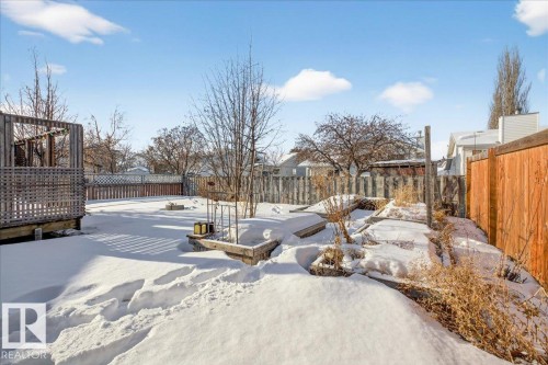 Yard layered in snow with a fenced backyard - 2516 42 Street, Edmonton, AB - Outdoor