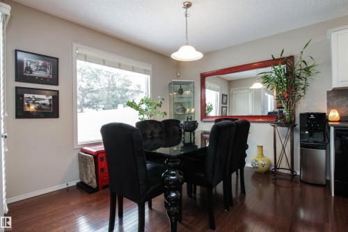 Dining area with dark wood-style flooring and a textured ceiling - 2315 Lemieux Place, Edmonton, AB - Indoor Photo Showing Dining Room