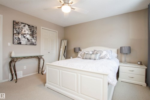 Bedroom featuring a closet, light carpet, and ceiling fan - 2315 Lemieux Place, Edmonton, AB - Indoor Photo Showing Bedroom
