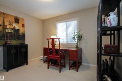 Office area featuring light carpet and a textured ceiling - 