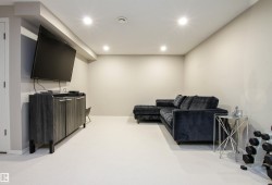 Living room with recessed lighting and light colored carpet - 