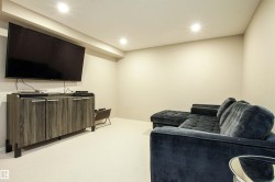 Carpeted living area featuring recessed lighting and baseboards - 