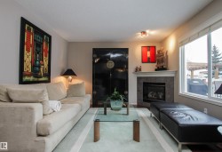 Living area featuring a fireplace and a textured ceiling - 