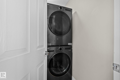 Washroom with stacked washer / drying machine - 46 13825 155 Avenue, Edmonton, AB - Indoor Photo Showing Laundry Room