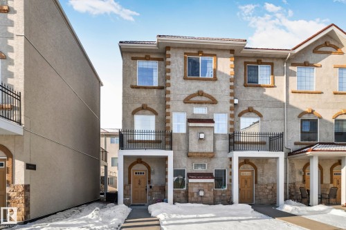 View of front of property with a balcony and stone siding - 46 13825 155 Avenue, Edmonton, AB - Outdoor With Balcony With Facade
