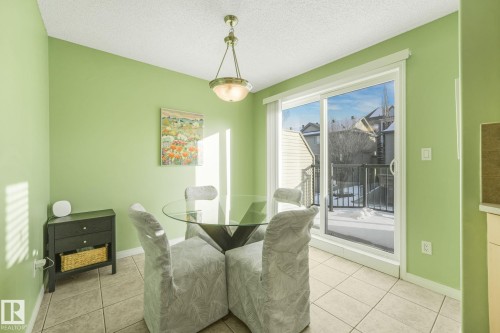 Dining room with light tile patterned floors and a textured ceiling - 23 4755 Terwillegar Common, Edmonton, AB - Indoor Photo Showing Other Room