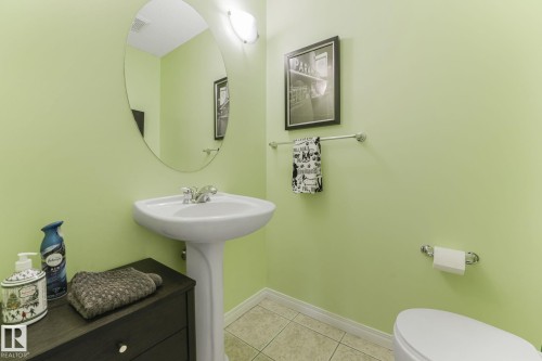 Half bath with baseboards and light tile patterned flooring - 23 4755 Terwillegar Common, Edmonton, AB - Indoor Photo Showing Bathroom