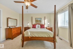 Bedroom with light carpet, a textured ceiling, and a ceiling fan - 