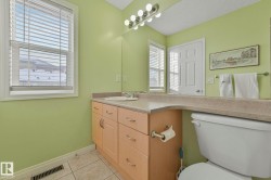 Bathroom with vanity and light tile patterned floors - 