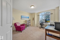 Office area featuring light carpet and a textured ceiling - 