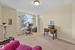Office area featuring light carpet and a textured ceiling - 