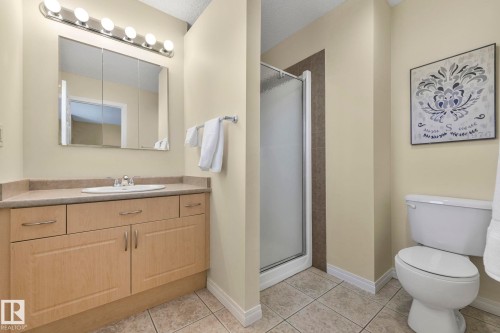 Bathroom featuring a shower stall, vanity, and light tile patterned floors - 23 4755 Terwillegar Common, Edmonton, AB - Indoor Photo Showing Bathroom
