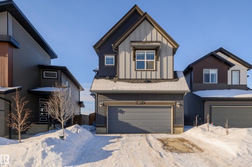 View of front of home with board and batten siding and a garage - 37 Rhea Crescent, St. Albert, AB - Outdoor With Facade