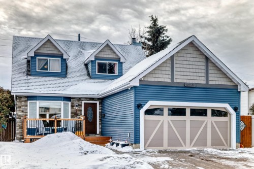 View of front of house with a chimney, a garage, and stone siding - 18931 80 Avenue, Edmonton, AB - Outdoor