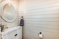 Bathroom with vanity and wood walls - 