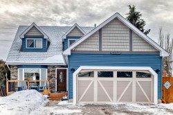 Craftsman-style home featuring a wooden deck and stone siding - 