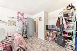 Bedroom with a textured ceiling and wood finished floors - 