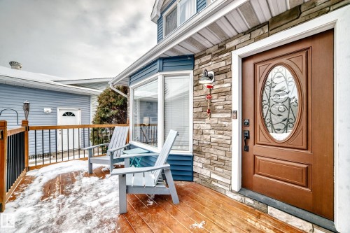 Property entrance featuring stone siding and a wooden deck - 18931 80 Avenue, Edmonton, AB - Outdoor With Deck Patio Veranda