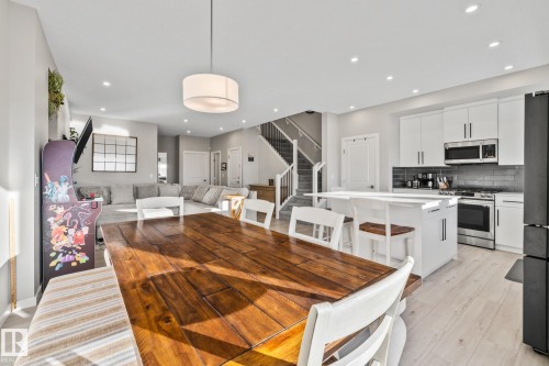Dining room featuring stairway, recessed lighting, and light wood finished floors - 217 Larch Crescent, Leduc, AB - Indoor