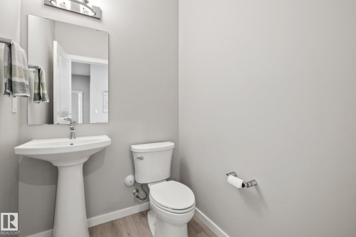 Bathroom featuring baseboards and wood finished floors - 217 Larch Crescent, Leduc, AB - Indoor Photo Showing Bathroom