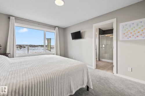 Bedroom with carpet and ensuite bath - 217 Larch Crescent, Leduc, AB - Indoor Photo Showing Bedroom