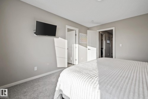 Bedroom featuring baseboards and carpet floors - 217 Larch Crescent, Leduc, AB - Indoor Photo Showing Bedroom