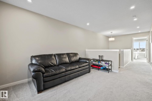 Living area featuring recessed lighting and light carpet - 217 Larch Crescent, Leduc, AB - Indoor